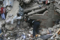 <p>A construction worker searches a building that collapsed after an earthquake, in the Roma neighborhood of Mexico City, Tuesday, Sept. 19, 2017. A magnitude 7.1 earthquake has rocked central Mexico, killing at least 55 people as buildings collapsed in plumes of dust and thousands fled into the streets in panic. (AP Photo/Eduardo Verdugo) </p>