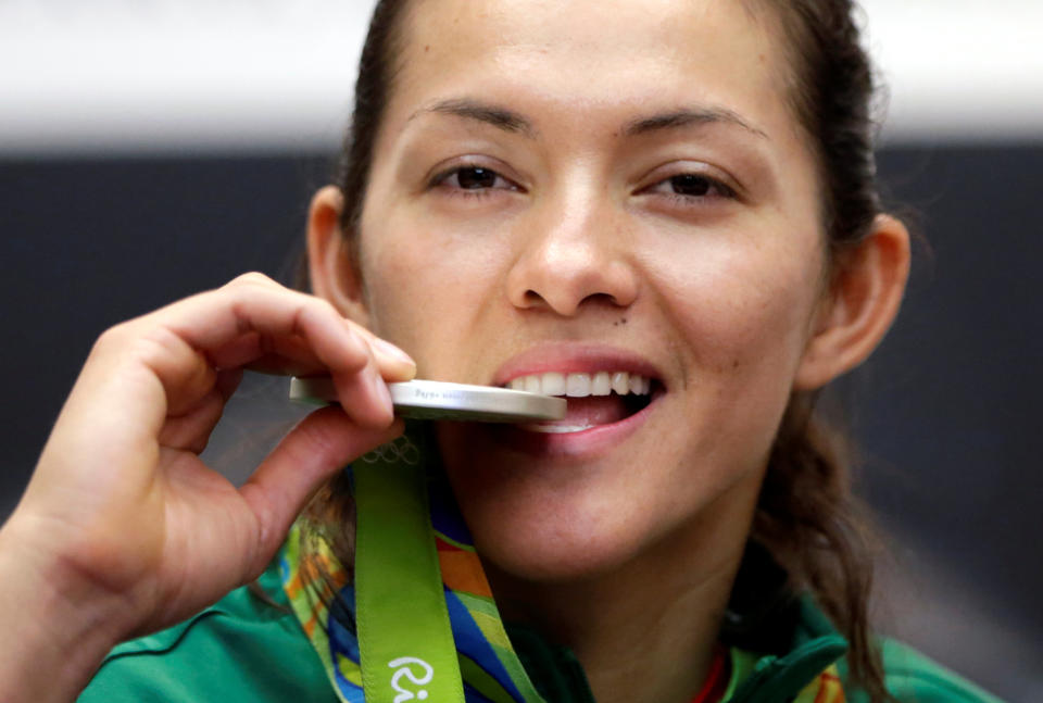 Maria del Rosario Espinoza, taekwondo Olympic silver medallist, poses with her medal during a news conference after her return from the 2016 Rio Olympics at the international airport in Mexico City, Mexico, August 24, 2016. REUTERS/Henry Romero