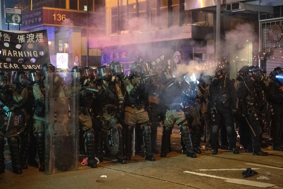 HONG KONG, CHINA - JULY 28: Riot police fire tear gas during a demonstration in the area of Sheung Wan on July 28, 2019 in Hong Kong, China. Pro-democracy protesters have continued weekly rallies on the streets of Hong Kong against a controversial extradition bill since 9 June as the city plunged into crisis after waves of demonstrations and several violent clashes. Hong Kong's Chief Executive Carrie Lam apologized for introducing the bill and recently declared it "dead", however protesters have continued to draw large crowds with demands for Lam's resignation and completely withdraw the bill. (Photo by Laurel Chor/Getty Images)