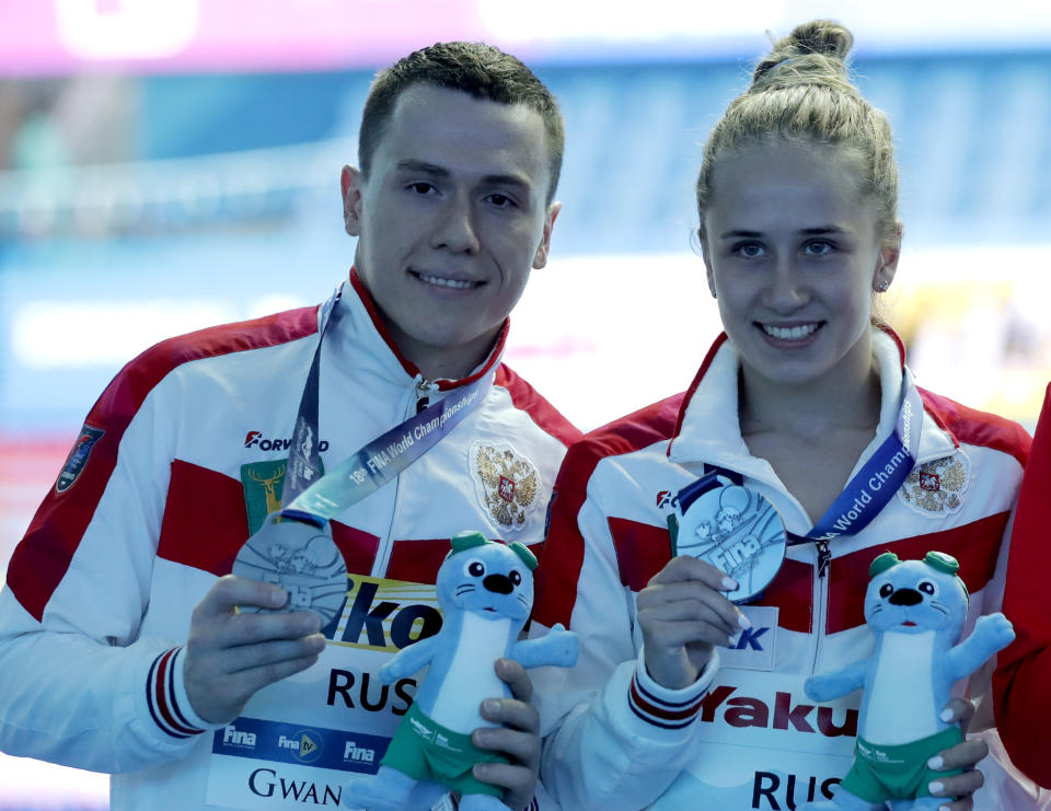 Russia's Sergey Nazin and Iuliia Timoshinina pose with their silver medals for the mixed team event diving final at the World Swimming Championships in Gwangju, South Korea, Tuesday, July 16, 2019. (AP Photo/Lee Jin-man )