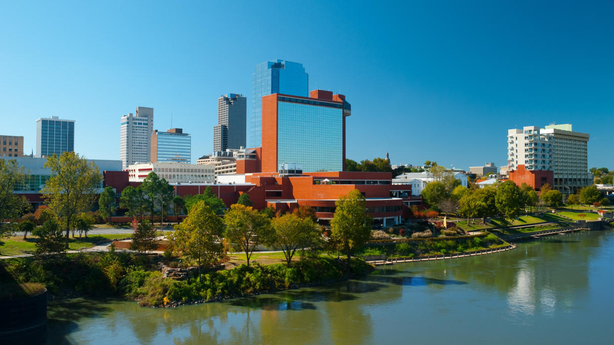 Downtown Little Rock skyline with the Arkansas River in the foreground.