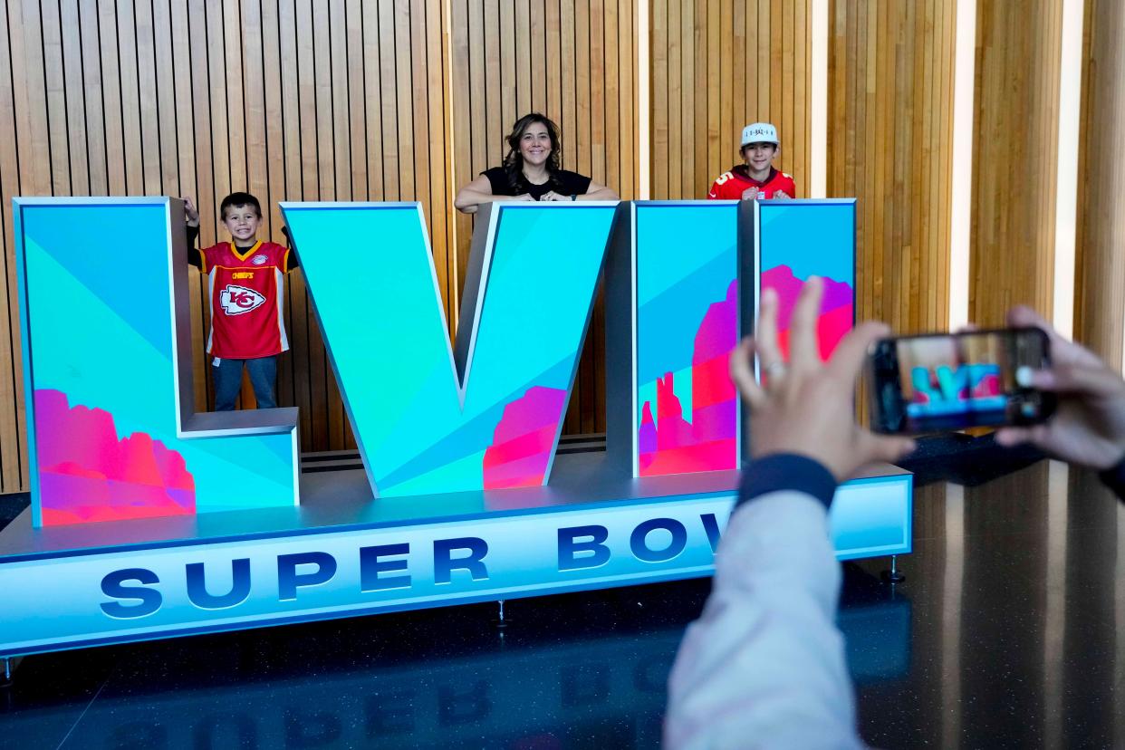 Fans pose before the NFL football Super Bowl 57 opening night on Monday 6 February 2023 (AP)