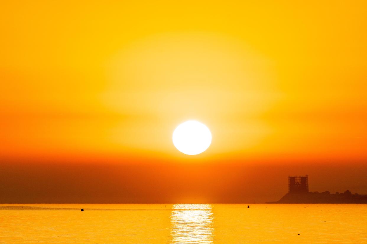 UK Weather. Herne Bay, Kent, UK. 8th September 2023 The sunrise over the sea at the coastal resort of Herne Bay this morning. The twin towers are the 11th century ruined church of Reculver, now undergoing a multi million facelift. Credit-Malcolm Fairman, Alamy Live News.