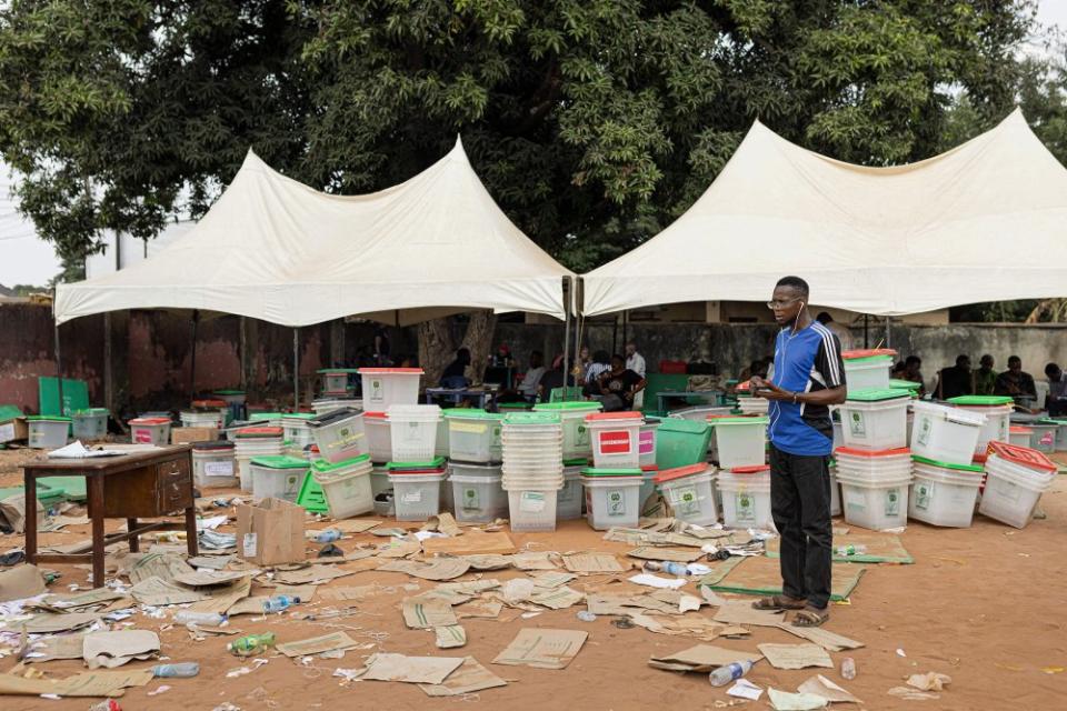 An Independent National Electoral Commission official speaks on the phone at the INEC offices in Awka, Nigeria, on Feb. 26 following the Nigeria presidential and general election.<span class="copyright">Patrick Meinhardt—AFP/Getty Images</span>