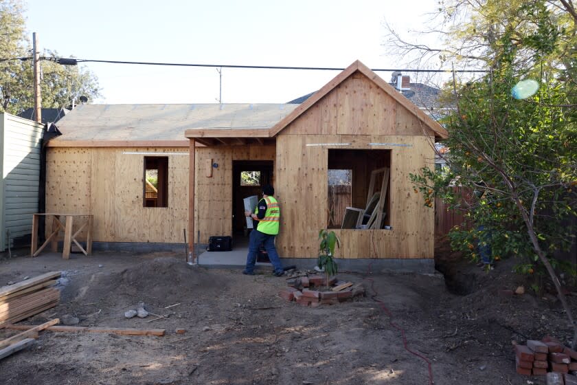 LOS ANGELES, CA - FEBRUARY 18: Andrew Aguayo works on an Accessory Dwelling Unit being built on Katherine Guevara and David Guevara Rosillo's property in West Adams on Thursday, Feb. 18, 2021 in Los Angeles, CA. They are participating in a new initiative called Backyard Homes, where participating homeowners receive help building a ADU in their backyard and in exchange they agree to rent the mini home to a low-income Section 8 resident. (Dania Maxwell / Los Angeles Times)