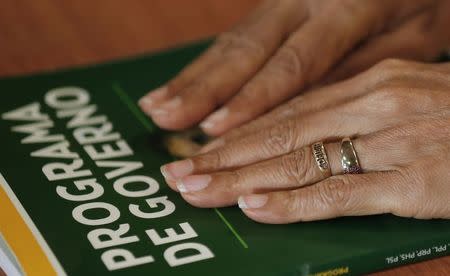 The hands of presidential candidate Marina Silva of the Brazilian Socialist Party (PSB) are seen placed on her government programme during an interview with Reuters in Rio de Janeiro September 25, 2014. REUTERS/Sergio Moraes