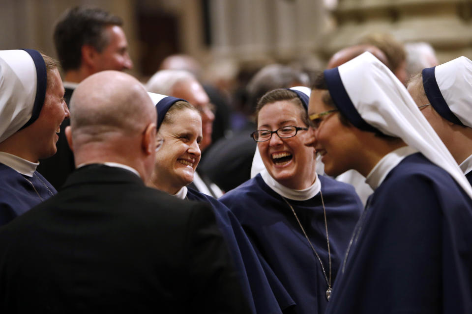 A group of nuns laugh inside St. Patrick's Cathedral as they wait for Pope Francis to lead an evening prayer service, Thursday, Sept. 24, 2015, in New York. (AP Photo/Jason DeCrow)
