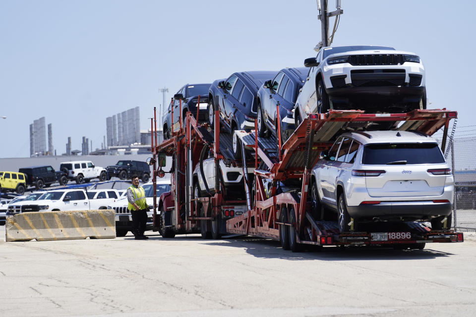 File - A truck loaded with new cars arrives arrives at the Stellantis Belvidere Assembly Plant on Monday, July 10, 2023, in Belvidere. Ill. On Thursday, the Labor Department releases the producer price index for June, an indicator of inflation at the wholesale level.(AP Photo/Charles Rex Arbogast, File)