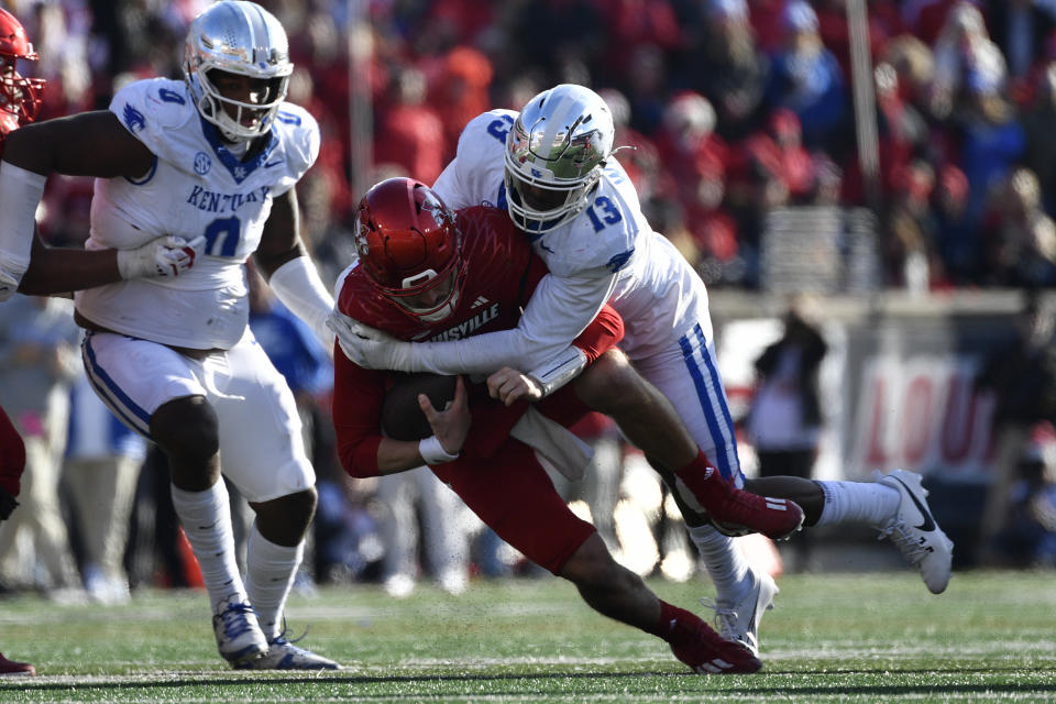 Kentucky linebacker J.J. Weaver (13) sacks Louisville quarterback Jack Plummer (13) during the second half of an NCAA college football game in Louisville, Ky., Saturday, Nov. 25, 2023. Kentucky won 38-31. (AP Photo/Timothy D. Easley)