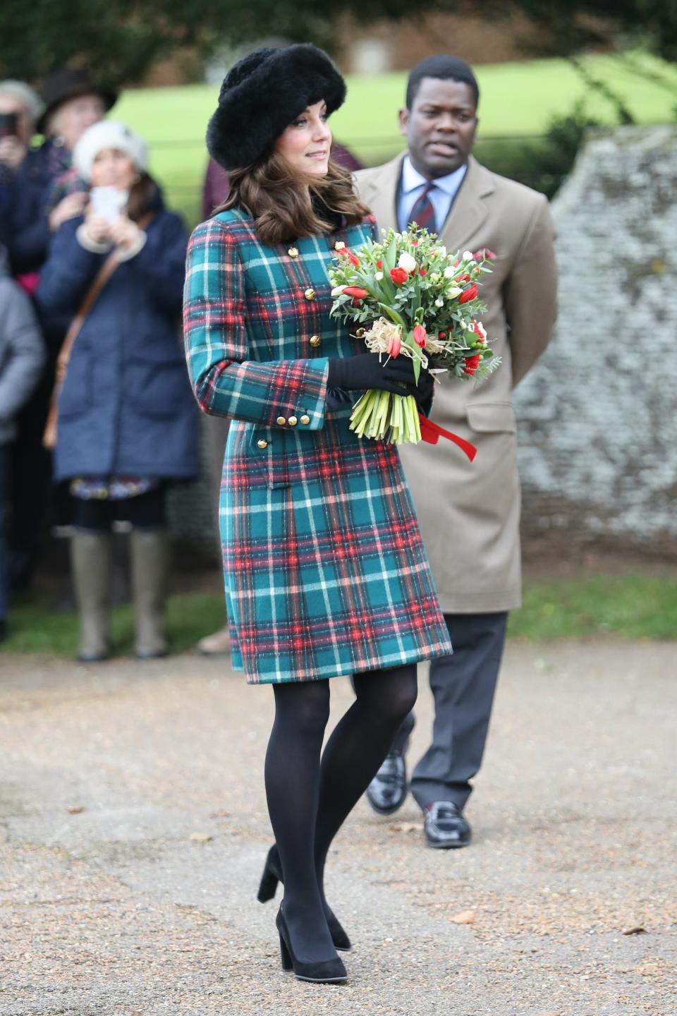 Kate Middleton wears a tartan coat and fur hat in December 2017.