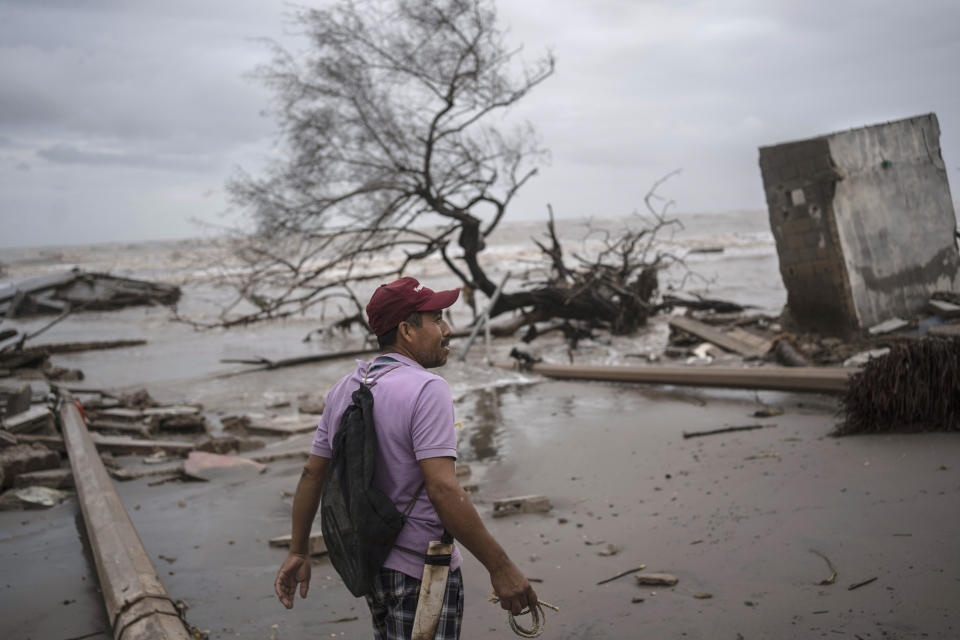 Fisherman Alberto Isidoro walks through his coastal community destroyed by flooding driven by a Gulf of Mexico sea-level rise in El Bosque, in the state of Tabasco, Mexico, Wednesday, Nov. 29, 2023. (AP Photo/Felix Marquez)