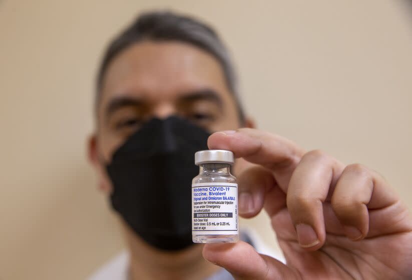 SOUTHGATE, CA-OCTOBER 6, 2022: Daniel Carrillo, a pharmacist at AltaMed in Southgate, holds a bottle containing booster doses of the Moderna COVID-19 vaccine, Bivalent, the updated booster from Moderna designed to help protect against multiple COVID-19 variants in a single shot. Earlier he administered this vaccine to Senator Alex Padilla. (Mel Melcon / Los Angeles Times)