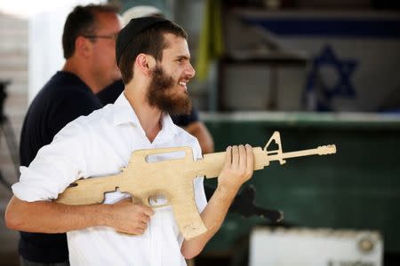 A tourist takes part in a two hour "boot camp" experience, at "Caliber 3 Israeli Counter Terror and Security Academy" in the Gush Etzion settlement bloc south of Jerusalem in the occupied West Bank July 13, 2017. Picture taken July 13, 2017. REUTERS/Nir Elias