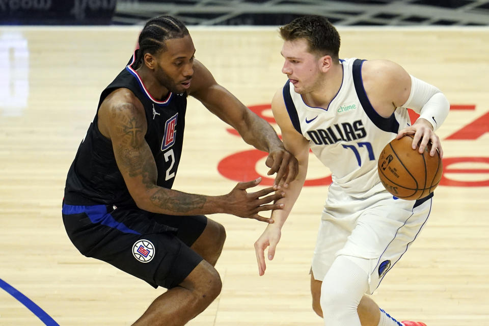 Dallas Mavericks guard Luka Doncic is guarded by Los Angeles Clippers forward Kawhi Leonard.