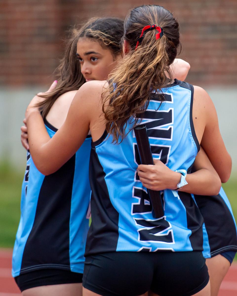 South Bend St. Joseph runners embrace after winning the 4x100 meter relay at the Mishawaka Girls IHSAA Sectional track meet Tuesday, May 17, 2022, at Mishawaka High School.