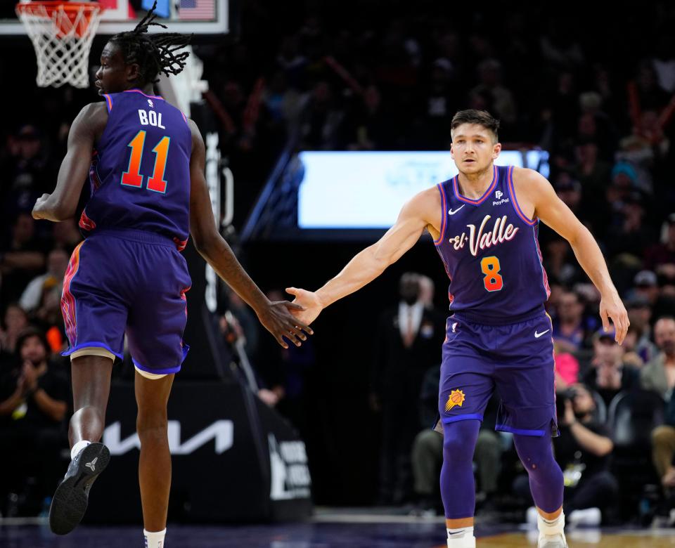 Jan. 5, 2024; Phoenix, Ariz; USA; Suns guard Grayson Allen (8) and center Bol Bol (11) celebrate an Allen three pointer against the Heat during the first half at the Footprint Center.