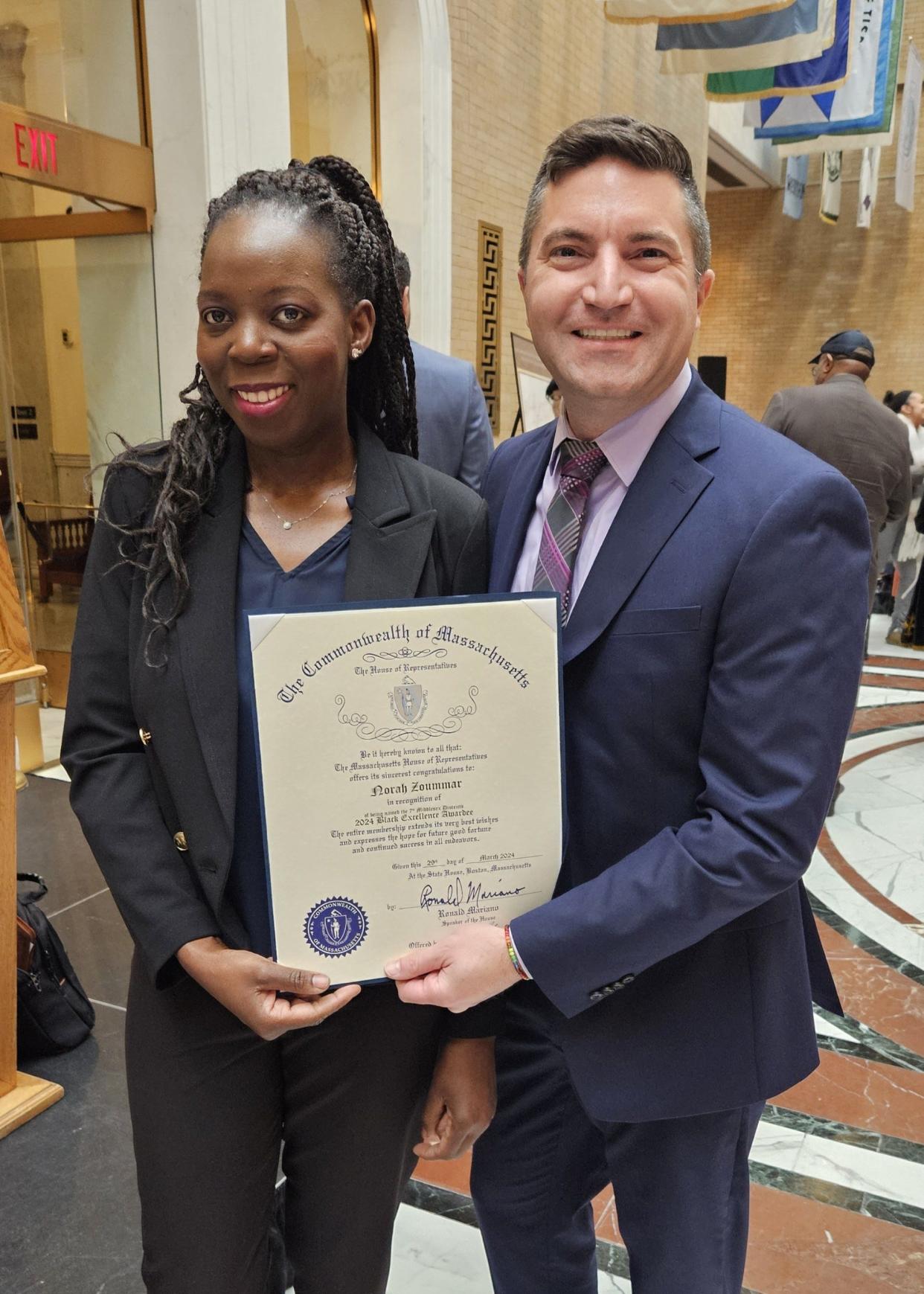 State Rep. Jack Patrick Lewis, D-Framingham, right, nominated Norah Zoummar for a Black Excellence Award for her work to support women and children in Uganda. The award is sponsored by the Massachusetts Black and Latino Legislative Caucus.