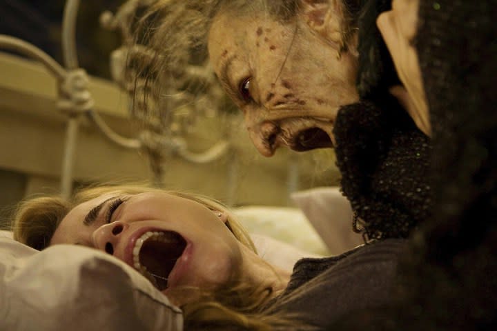 An undead elderly woman screams at Alison Lohman in Drag Me to Hell.