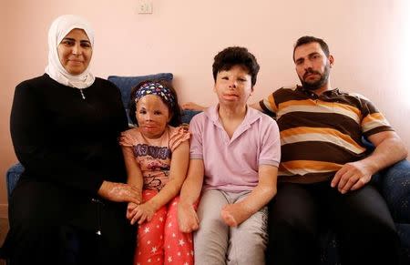 Muhammed Mazin Mekansi poses with his wife Mutia El Haffar, his daughter Limar and son Gheis at their home in Ankara, Turkey, August 22, 2016. REUTERS/Tumay Berkin