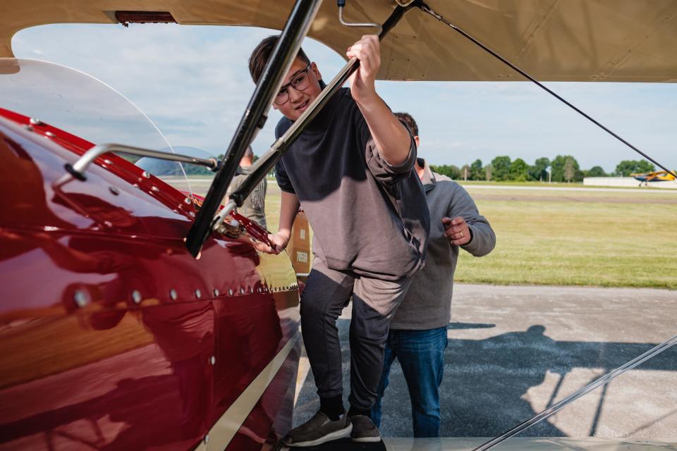 Cooper Winters, 12, prepares to board the Hatz biplane owned and operated by flight instructor Ryan Newell on Saturday at Harry Clever Field. Winters was among 14 middle school sudents who completed the nine-week Wright Flight course offered by Chapter 1077 of the Experimental Aircraft Association.