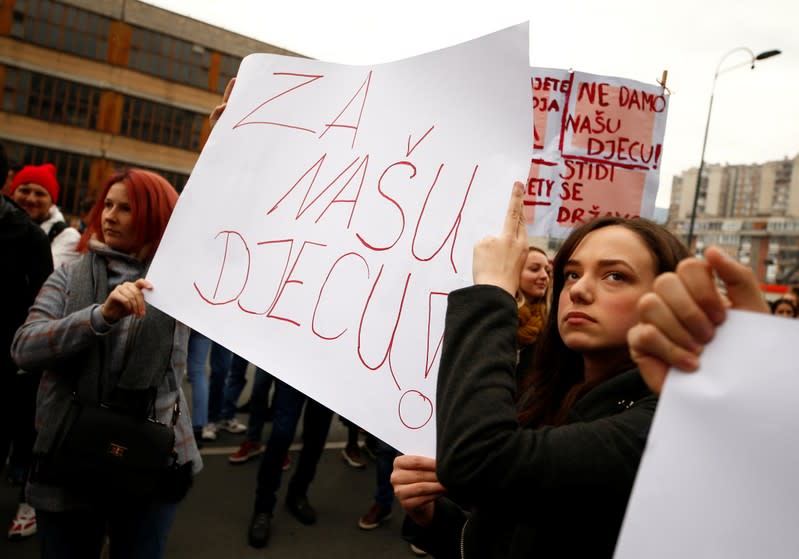 Protesters hold a placard saying "For our children" during a protest against abuse in an institution for children with special needs after photographs emerged of children tied to beds and radiators, in Sarajevo