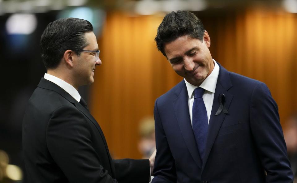 Prime Minister Justin Trudeau and Conservative leader Pierre Poilievre greet each other as they gather in the House of Commons to pay tribute to Queen Elizabeth in Ottawa on Sept. 15, 2022. THE CANADIAN PRESS/Sean Kilpatrick