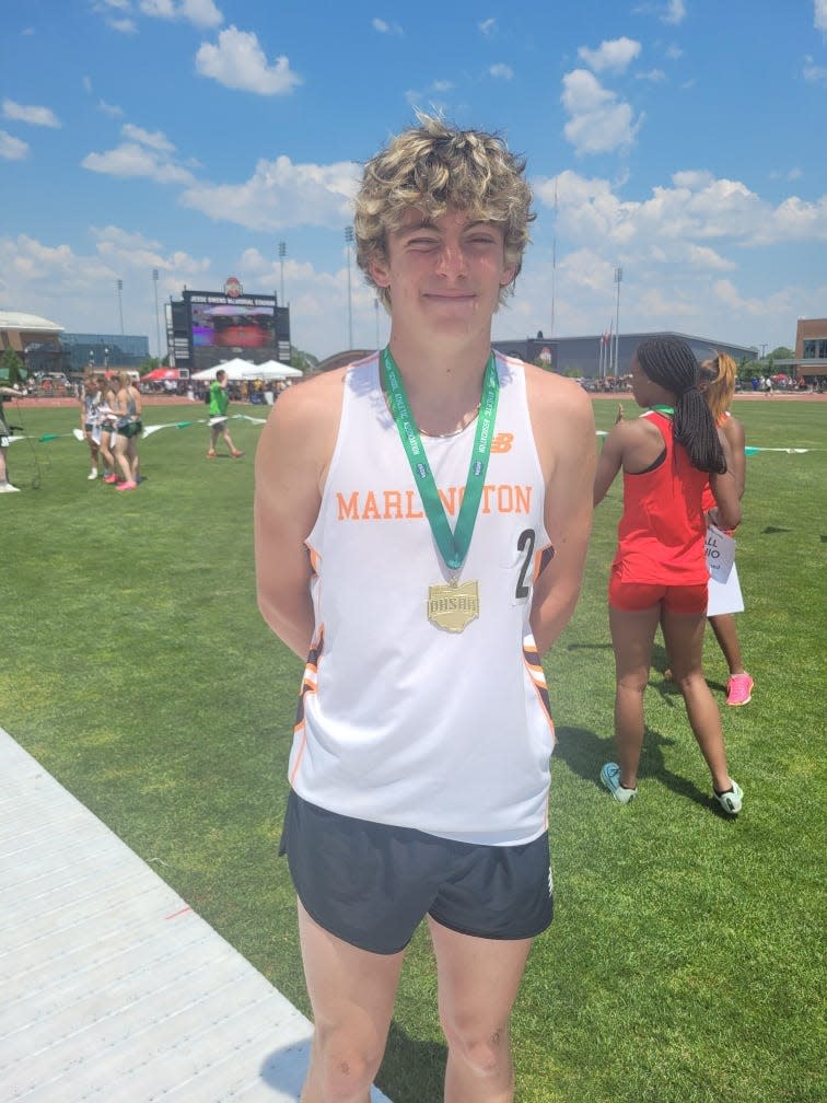 Colin Cernansky of Marlington with his state championship medal for the boys Division II 1,600 meters.