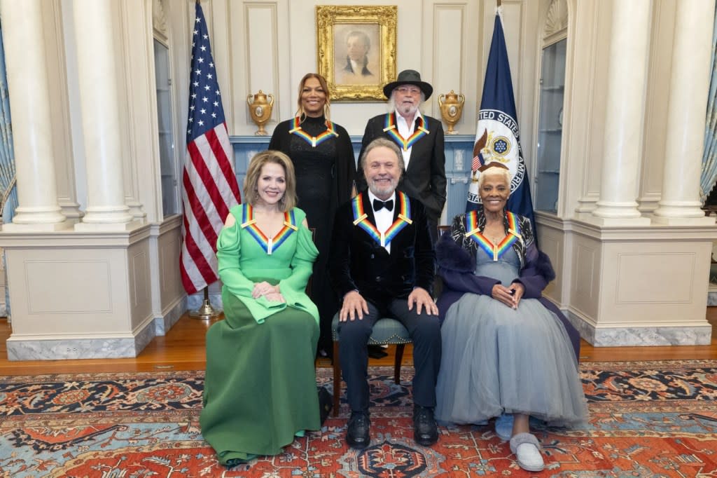 From left, 2023 Kennedy Center Honorees Renée Fleming, Queen Latifah, Billy Crystal, Barry Gibb and Dionne Warwick pose for a photo at the State Department following the Kennedy Center Honors gala dinner, Saturday, Dec. 2, 2023, in Washington. (AP Photo/Kevin Wolf)