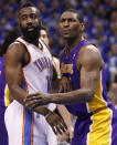 Los Angeles Lakers forward Metta World Peace, left, and Oklahoma City Thunder guard James Harden (13) jockey for position as they wait for the ball to be inbounded during the first quarter of Game 1 in the second round of the NBA basketball playoffs, in Oklahoma City, Monday, May 14, 2012. (AP Photo/Sue Ogrocki)