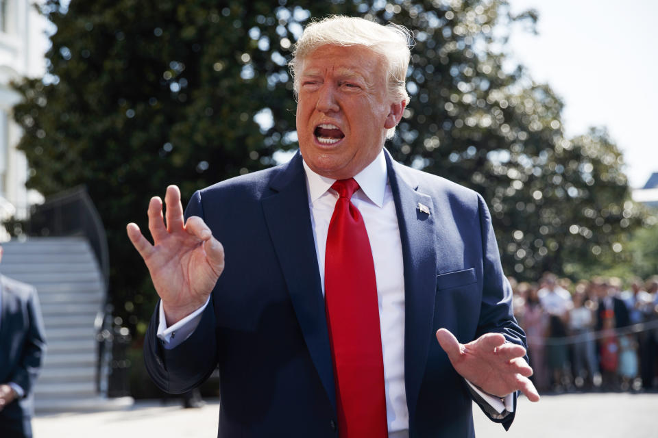 President Donald Trump talks to reporters on the South Lawn of the White House, Friday, Aug. 9, 2019, in Washington, as he prepares to leave Washington for his annual August holiday at his New Jersey golf club. (AP Photo/Evan Vucci)