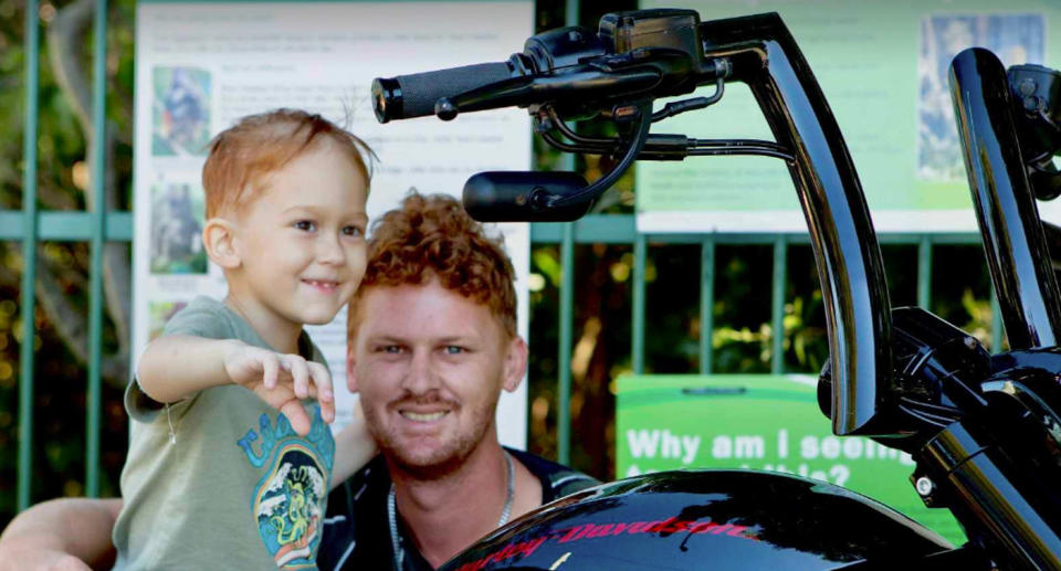 Calib can be seen on a motorbike with his Dad Joseph holding onto him and smiling at the camera. 