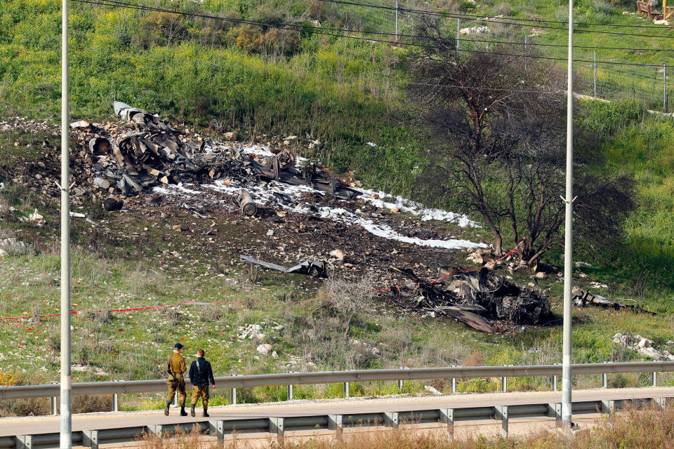 <p>A picture taken in the northern Israeli Kibbutz of Harduf on Feb. 10, 2018, shows the remains of an Israel F-16 that crashed after coming under fire by Syrian air defences during attacks against “Iranian targets” in the war-torn country. (Photo: Jack Guez/AFP/Getty Images) </p>