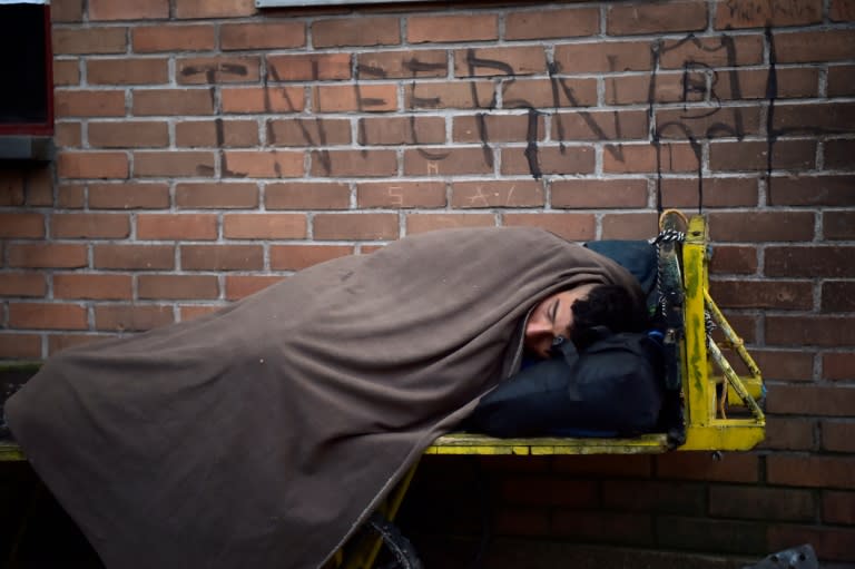 A Venezuelan migrant rests at the border between Colombia and Ecuador on August 11, 2018