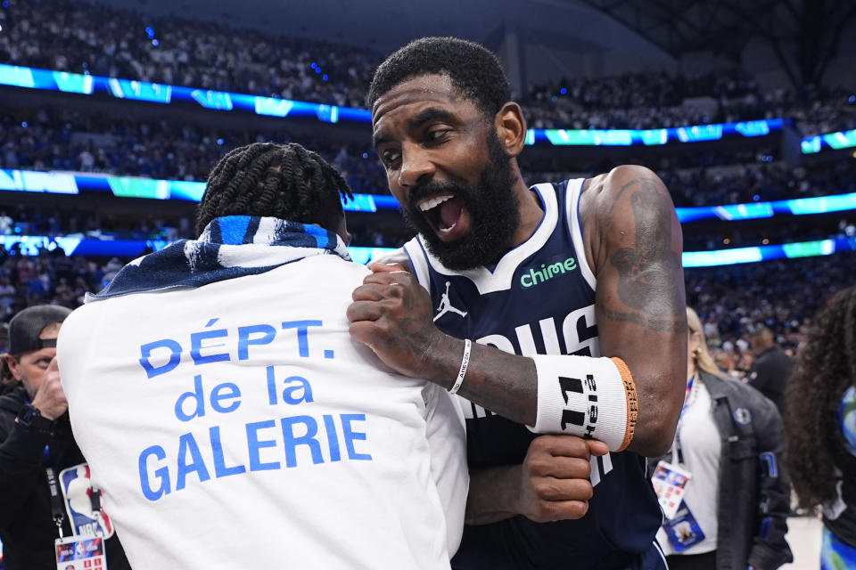 Dallas Mavericks guard Kyrie Irving, right, celebrates with teammates after their win over the Minnesota Timberwolves in Game 3 of the NBA basketball Western Conference finals, Sunday, May 26, 2024, in Dallas. (AP Photo/Julio Cortez)