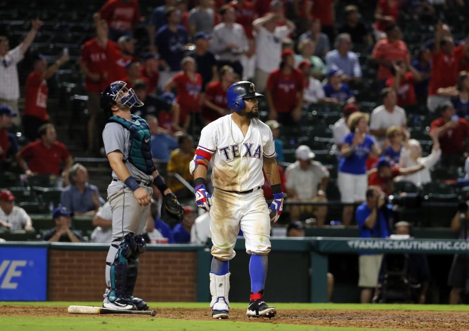 Rougned Odor watches his homer as Mariners catcher Mike Zunino watches in despair. (AP)