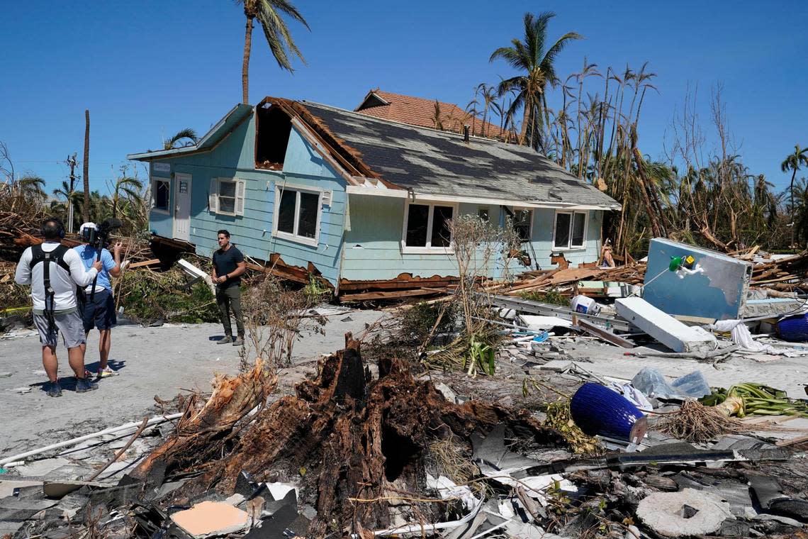 A TV news crew works on Sanibel Island, in the aftermath of Hurricane Ian, Friday, Sept. 30, 2022, on Sanibel Island, Fla. (AP Photo/Steve Helber)