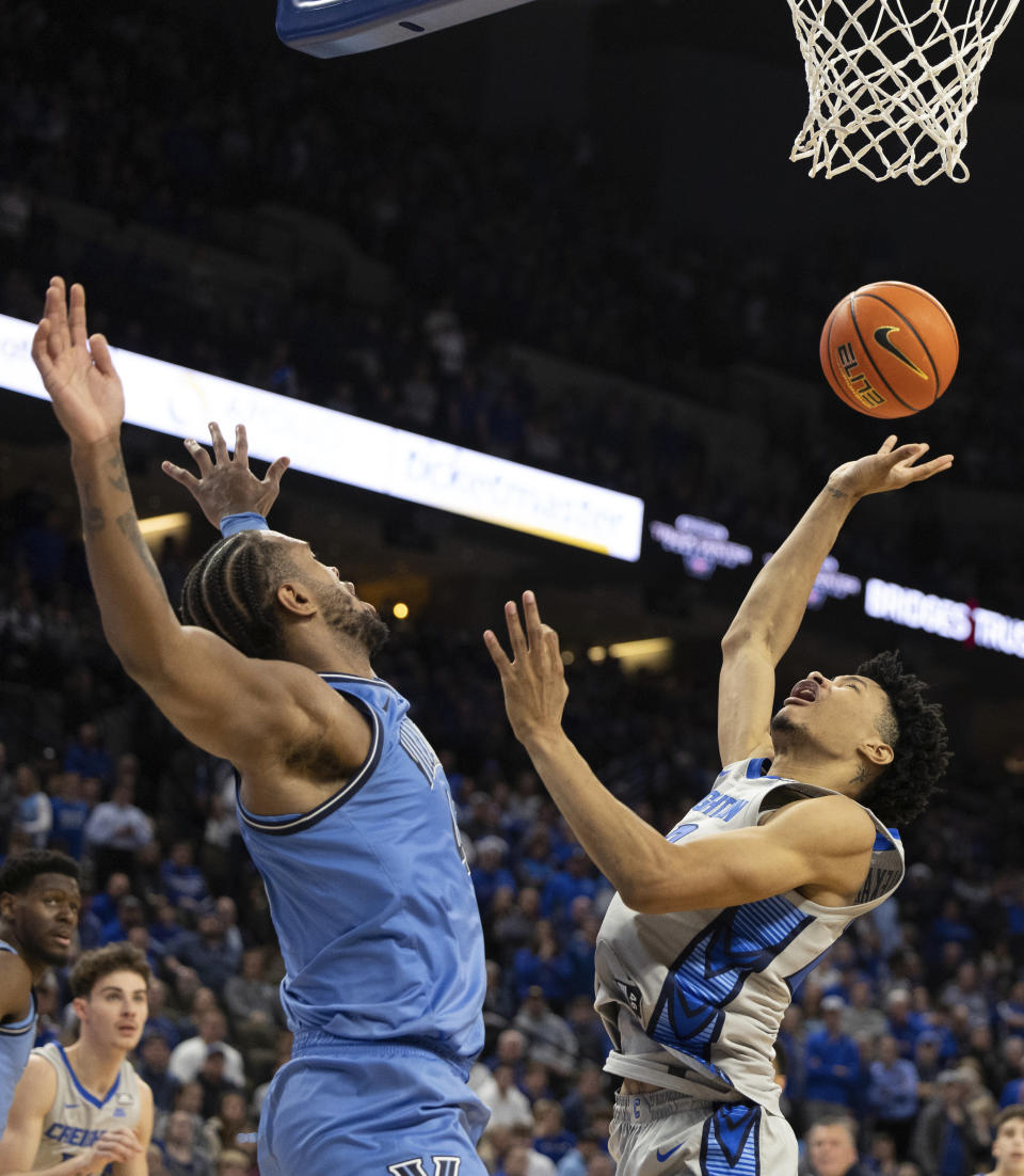 Creighton's Trey Alexander, right, shoots against Villanova's Eric Dixon during overtime in an NCAA college basketball game Wednesday, Dec. 20, 2023, in Omaha, Neb. (AP Photo/Rebecca S. Gratz)