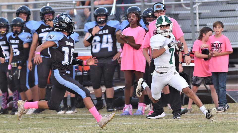 Hamlin's Zayiman Montoya (7) runs down the sideline as TLCA-Abilene's Johnathon Rico gives chase. Hamlin beat the Eagles 65-0 in the District 6-2A Division II game Thursday in Hawley.