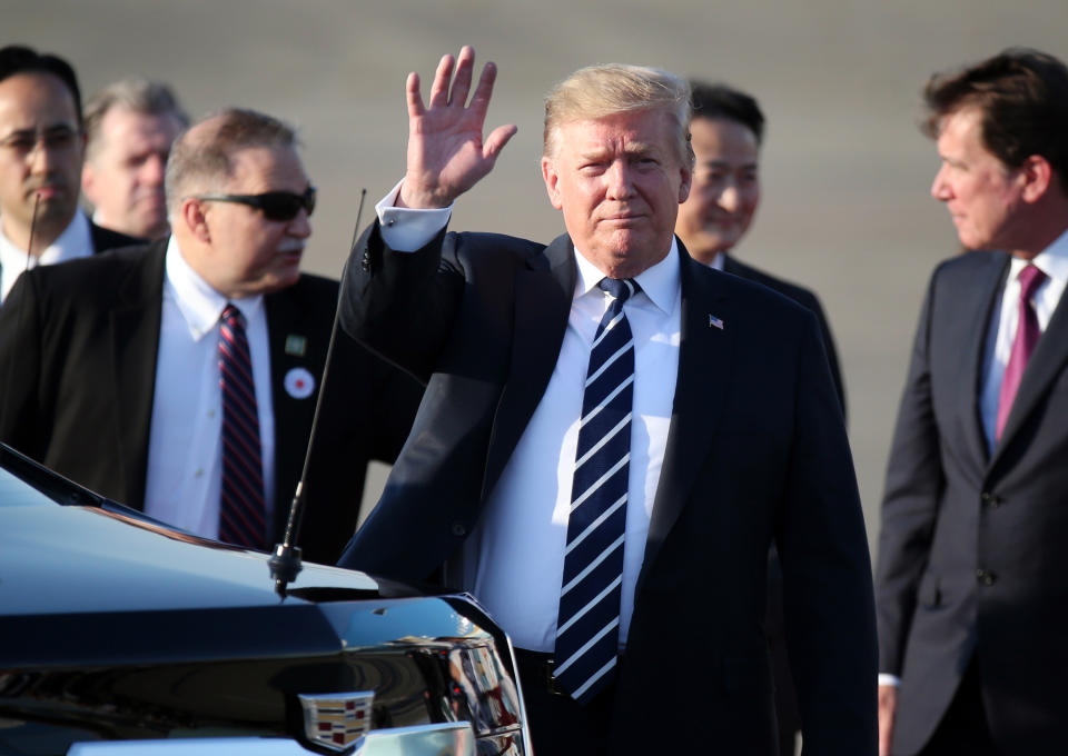 U.S. President Donald Trump waves as he arrives at the Haneda International Airport Saturday, May 25, 2019, in Tokyo. (AP Photo/Koji Sasahara, Pool)