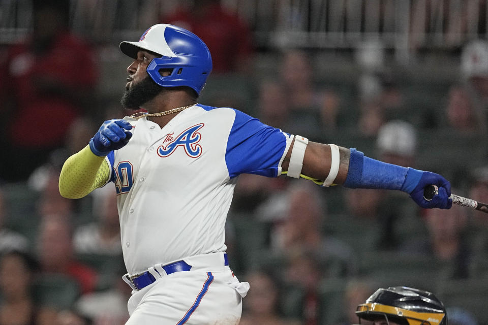 Atlanta Braves designated hitter Marcell Ozuna (20) watches his two-run home run against the Milwaukee Brewers during the seventh inning of a baseball game Saturday, July 29, 2023, in Atlanta. (AP Photo/John Bazemore)