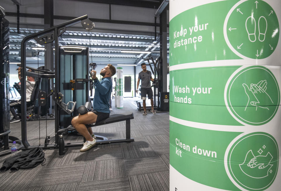 Gym members work out on socially-distanced fitness machines at the new PureGym Local in Kirkcaldy, Fife. (Photo by Jane Barlow/PA Images via Getty Images)