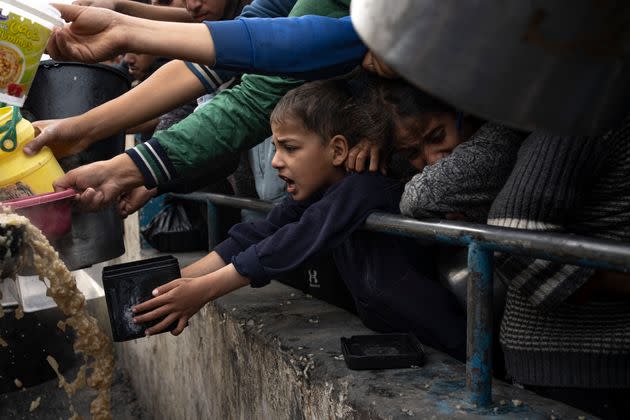 Palestinians line up for a free meal in Rafah, Gaza, on Dec. 21. International aid agencies said Gaza is suffering from shortages of food, medicine and other basic supplies as a result of the 2 1/2-month war between Israel and Hamas.