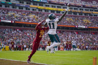 FILE Philadelphia Eagles wide receiver A.J. Brown (11) making a one-handed catch to score a touchdown against Washington Commanders cornerback Benjamin St-Juste (25) during the first half of an NFL football game, Sunday, Oct. 29, 2023, in Landover, Md. Brown was voted one of the top five wide receivers at the midpoint of the season by The Associated Press.(AP Photo/Alex Brandon, File)