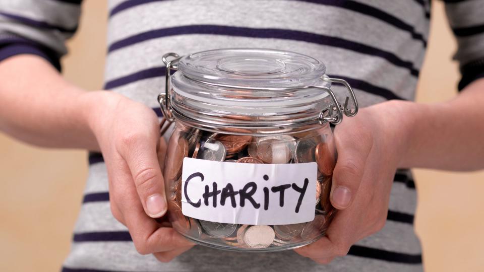 best ways to memorialize your pet — person holding charity pot