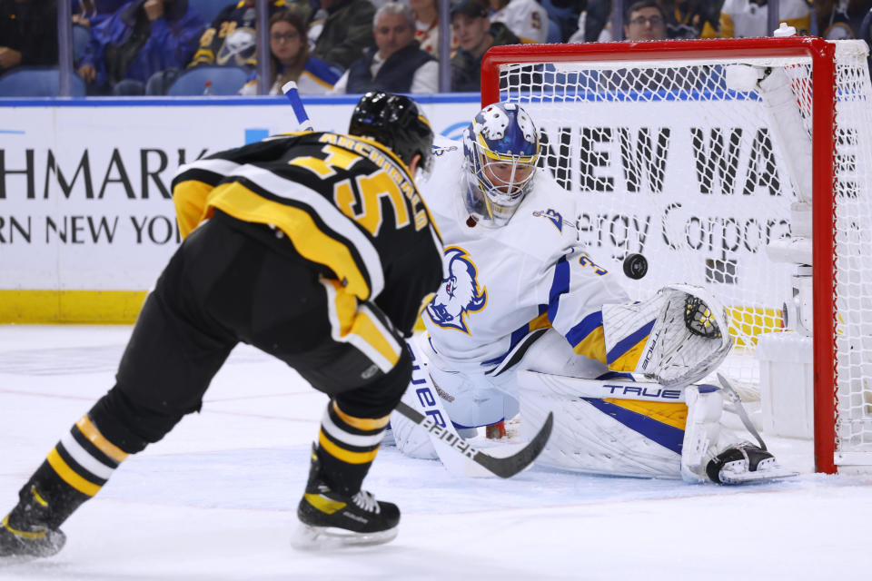 Pittsburgh Penguins right wing Josh Archibald (15) puts the puck past Buffalo Sabres goaltender Eric Comrie (31) during the second period of an NHL hockey game Wednesday, Nov. 2, 2022, in Buffalo, N.Y. (AP Photo/Jeffrey T. Barnes)