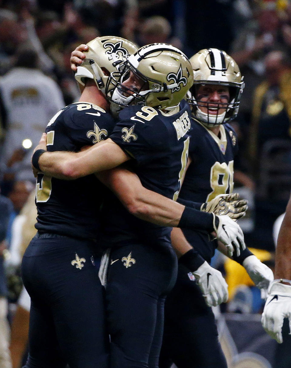 New Orleans Saints quarterback Drew Brees (9) hugs tight end Dan Arnold (85) after the two connected on a touchdown reception in the second half of an NFL football game against the Atlanta Falcons in New Orleans, Thursday, Nov. 22, 2018. (AP Photo/Butch Dill)