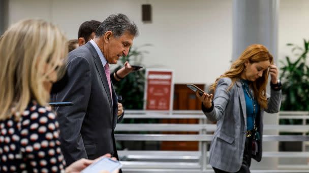 PHOTO: Sen. Joe Manchin is followed by reporters as he walks through the Senate Subway of the Capitol, Sept. 27, 2022. (Anna Moneymaker/Getty Images)