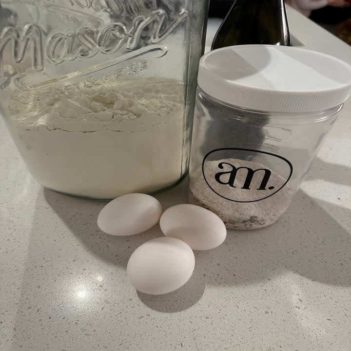 flour, eggs, and salt on the counter