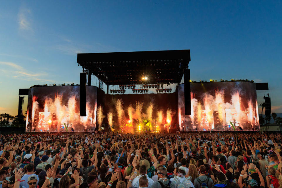 2017 Coachella main stage. The crowd has their hands up and there are pyrotechnics.