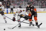 Anaheim Ducks center Leo Carlsson, right, and Chicago Blackhawks defenseman Jaycob Megna vie for the puck during the first period of an NHL hockey game Thursday, March 21, 2024, in Anaheim, Calif. (AP Photo/Ryan Sun)